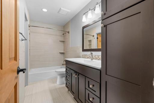 Main Floor Bathroom with Tile Surround and Floors