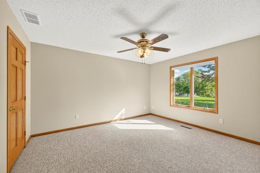 Primary suite with walk-in closet and attached bath