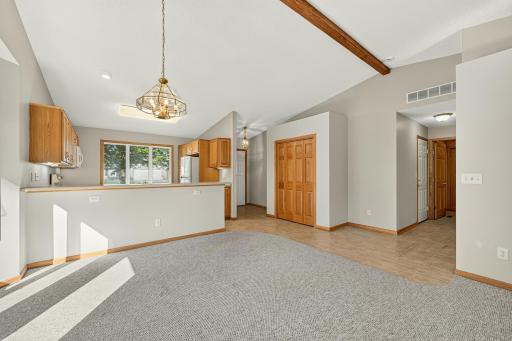 Open concept floor plan with vaulted beamed ceiling