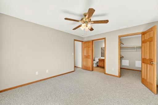 Primary suite with walk-in closet and attached bath