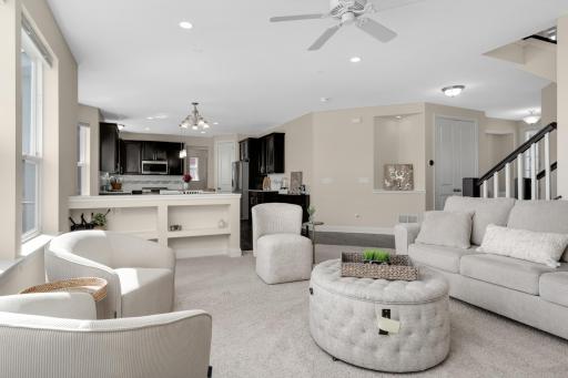 Open living room flowing seamlessly into kitchen and dining, perfect for entertaining.