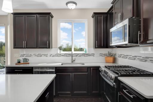 Bright kitchen with window over sink, tile backsplash, and beautiful natural light.