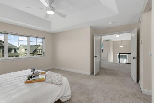 Primary bedroom with French doors and open layout, offering easy access to the upper-level loft.