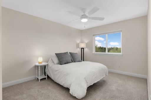 Spacious upper-level bedroom with natural light and peaceful views.