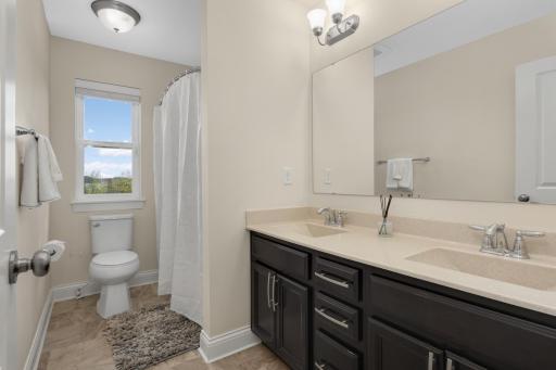 Upper-level full bath with dual vanities, ideal for multiple bedrooms.