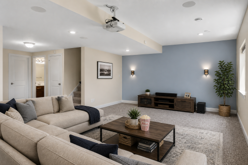 Expansive lower level featuring custom theater screen wall (specialty paint) and ceiling-mounted projector, perfect for movie nights. (virtually staged)
