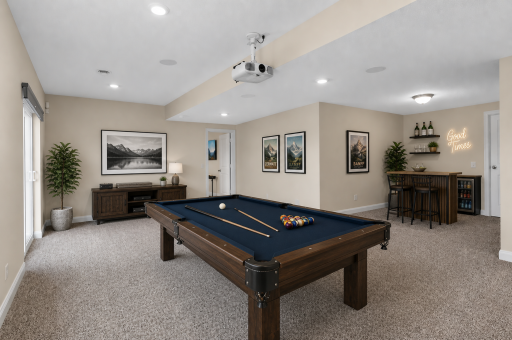 Large lower level with dedicated game space, ideal for pool table, entertaining, or future bar setup. (virtually staged)