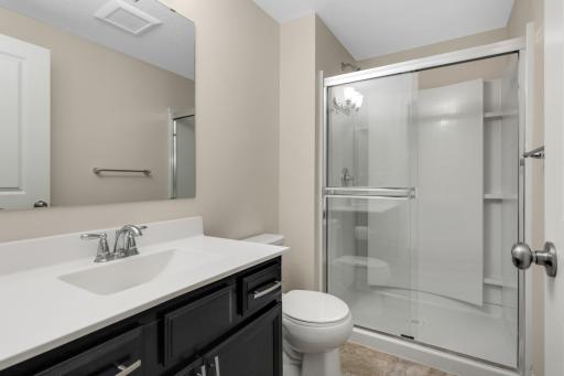 Convenient lower-level ¾ bath with walk-in shower, ideal for guests and entertaining.