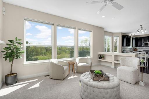 Expansive windows bringing in natural light and overlooking private, scenic views.