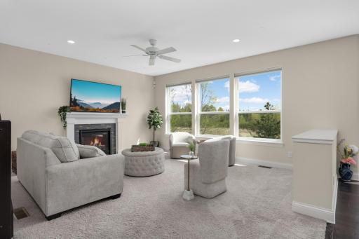 Light-filled living room with large windows showcasing peaceful nature views.