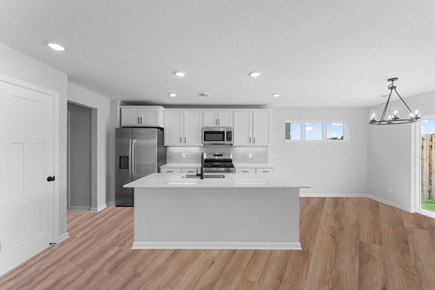 Kitchen with pantry, soft-close drawers! Walk out to backyard from patio door. INCLUDES a 12x12 patio.