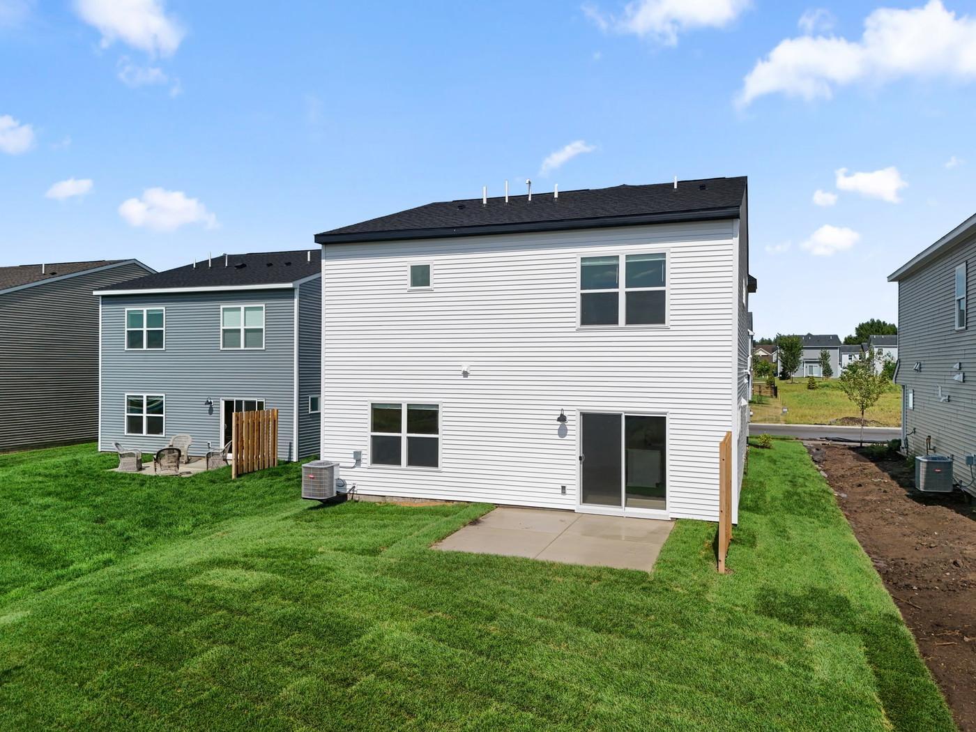 Exterior of home. Views of a pond. Patio and privacy fence with irrigation, sod and basic landscaping package included!
