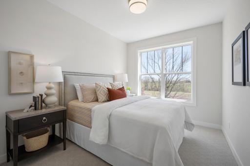 One of 5 bedrooms. ***Prices, square footage, Photos &/or illustrations do not depict actual home plan configuration. Materials/finishes shown contain options not included