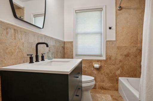 Remodeled main level full bath - grogeous tilewoork, updated vanity and fixtures.