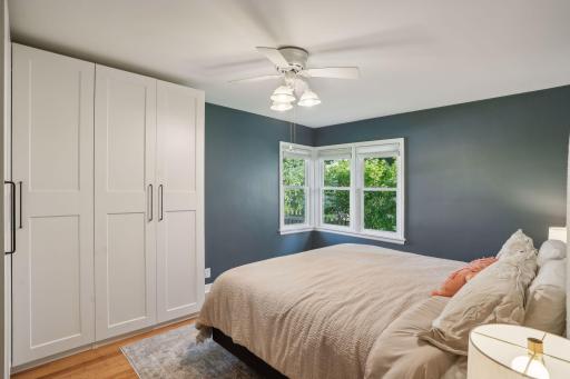 Main level bedroom with corner window and beautiful hardwood floors.