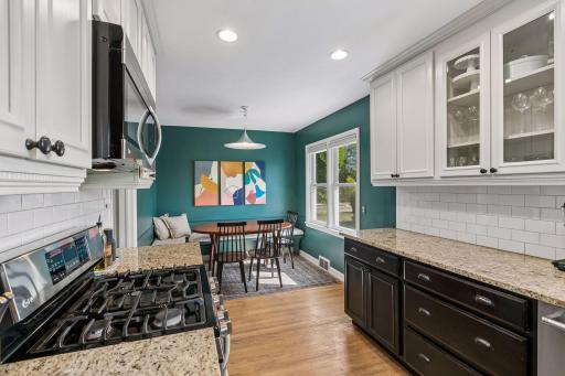 Designed to impress! Remodeled kitchen features Granite countertops, Stainless Steel appliances, updated cabinetry, tiled backsplash and a pop of stylish color in the attached informal dining area.