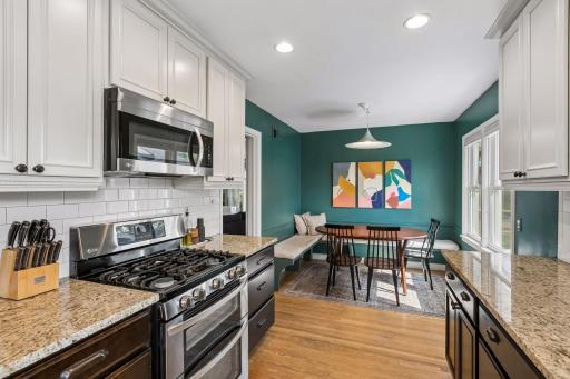 The beautifully remodeled kitchen is the heart of the home, featuring granite countertops, stainless-steel appliances, updated cabinetry, and an informal dining nook.