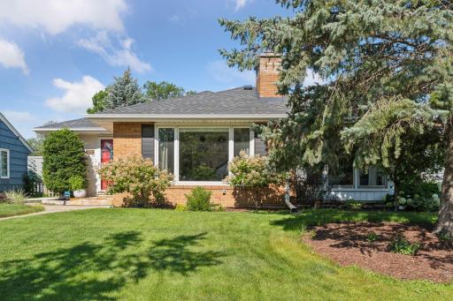 Standout curb appeal with newer roof (2021). Large front windows bring in a ton of natural light.