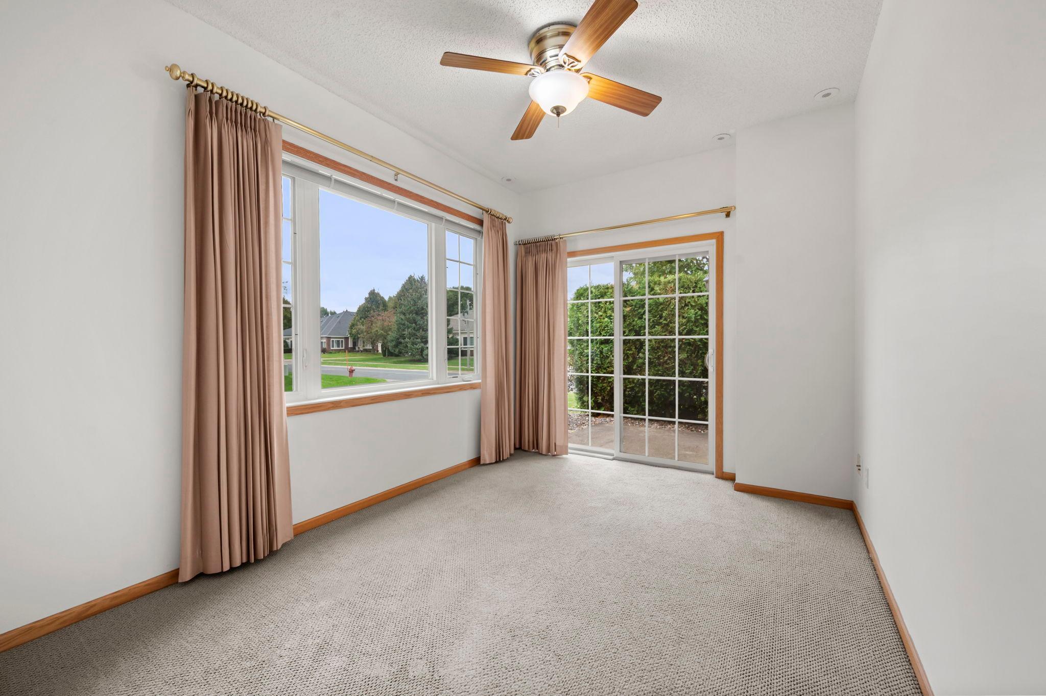 The sunroom is one of the home's most inviting spaces, with a sliding glass door opening to the patio. It’s a wonderful spot for morning coffee, a good book, or simply enjoying the changing seasons.