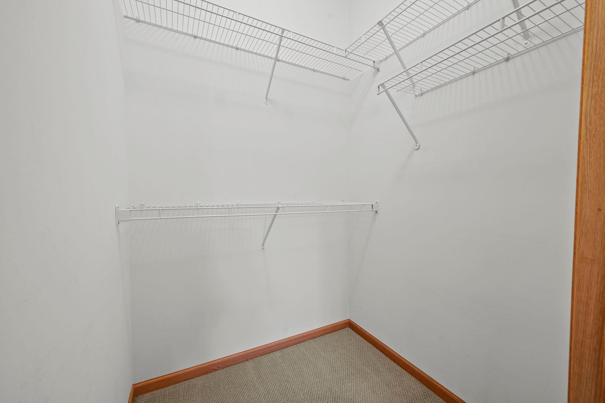 Primary suite walk-in closet with plenty of storage.