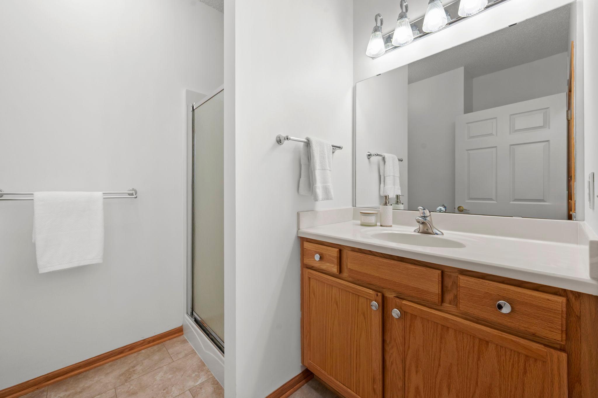 A conveniently located 3/4 bathroom features a shower and is easily accessible for guests and everyday use.