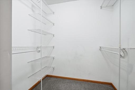 Walk-in closet offering ample shelving and hanging space to keep everything organized and easily accessible.