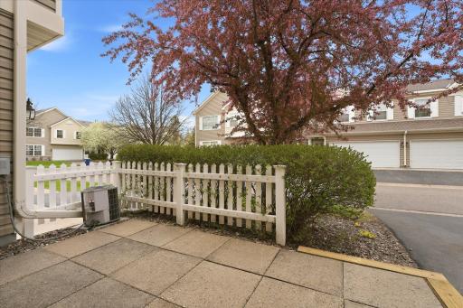 Private patio space with white picket fencing, perfect for relaxing, entertaining, or enjoying your morning coffee outdoors.