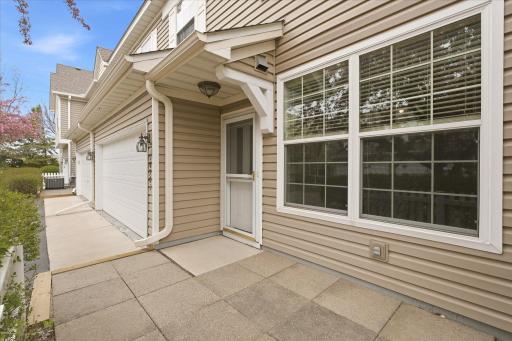 Covered front entry with spacious windows bringing in abundant natural light and showcasing the homeâs inviting exterior design.