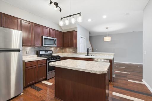 Entertain with ease in this functional open-concept kitchen complete with a raised breakfast bar, and generous prep space.