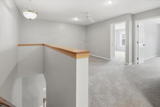 Spacious upper-level loft offers the perfect flex space for a second living area, home office, or workout room.