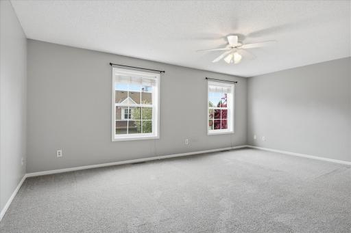 Spacious 19x12 primary suite featuring plush newer carpet, abundant natural light, and plenty of room for a king-size bed and additional furniture.