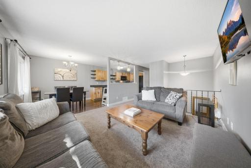 The spacious kitchen features beautiful wood cabinetry, ample cabinet and counter space, a newer dishwasher, and a pass-through to the living room that opens up the main level and creates a more connected feel.