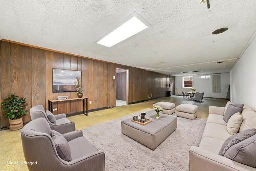 28-Basement Family Room with Egress- virtually staged.jpeg