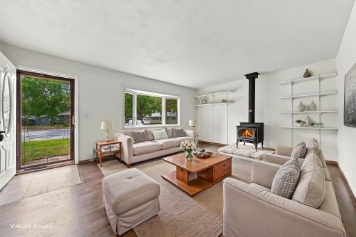 7 Large LR with wood burning stove- virtually staged.jpeg