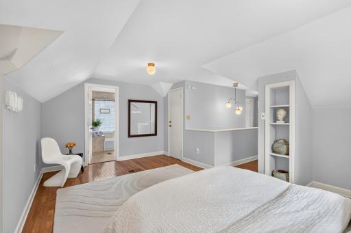 Dormer alcoves and hardwood floors give the primary suite its one-of-a-kind appeal.