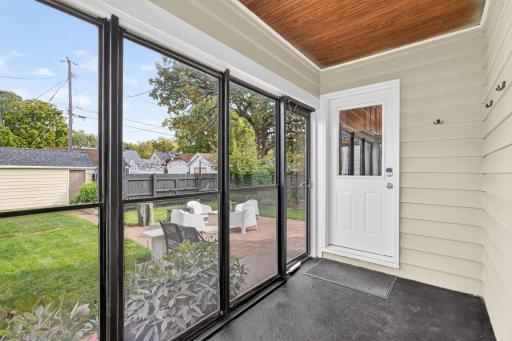 The screened-in back porch is perfect for morning coffee, doubles as a convenient mudroom just off the kitchen and offers lovely backyard views!