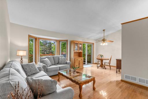 Upper level family room with view to dining area and sliding patio door out to deck