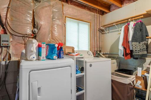 Lower level utility room with sink and washer and dryer