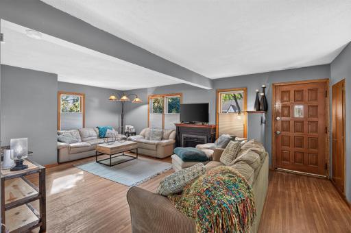 Spacious living room with hardwood floors and lots of windows for natural light, coat closet!