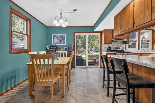 Informal dining, breakfast bar, slider window to back patio and yard.