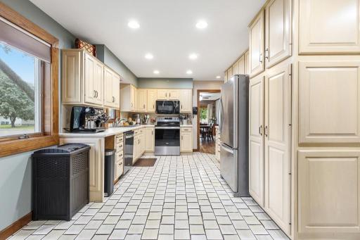 Bright and functional walk-through kitchen with gorgeous cream cabinets