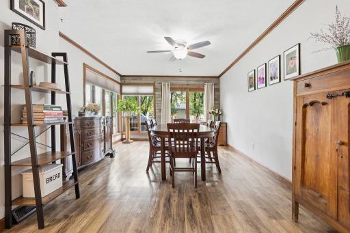 Natural light fills the space with large windows and patio door access to the deck