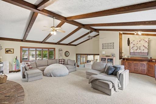 The spacious great room with vaulted ceiling and stunning wooden beams.