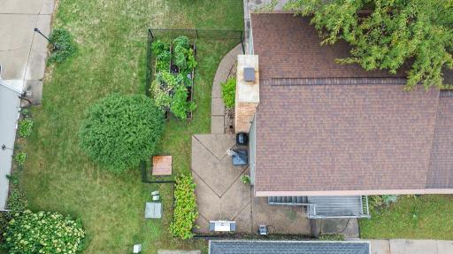 Overview of the enclosed fenced area, including a nice sized patio and raised garden beds.