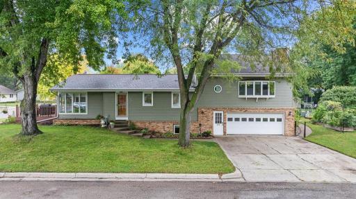 Stunning curb appeal with well-maintained landscaping and brick accents.
