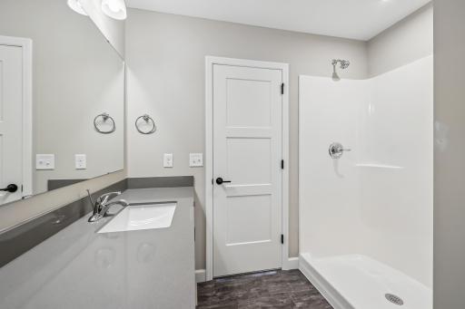 Lower level bath with full fiberglass shower base and surround.