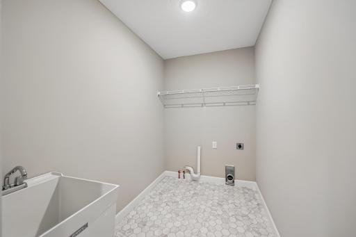 Main Level laundry with hook ups and shelf above.