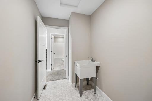 Laundry room is complete with a tub for all your laundry needs!