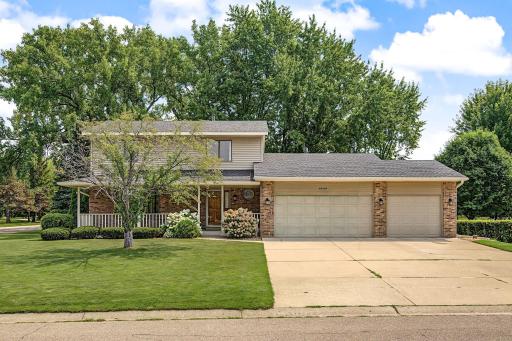 Stunning curb appeal with a newer roof (2023), a welcoming concrete front porch, and oversized concrete driveway.