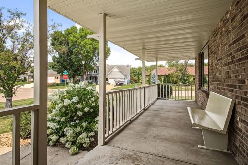 This spacious front porch welcomes family and friends to sit and relax and decorates beautifully for the holidays.